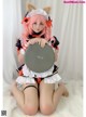 A woman in a maid outfit holding a drum.