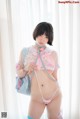 A woman in a pink and blue outfit is posing for a picture.