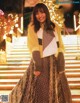 A woman standing in front of a set of stairs.