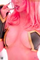 A woman with pink hair is posing for a picture.