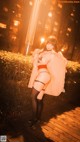 A woman in lingerie posing on a boardwalk at night.