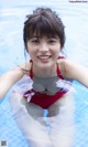 A woman in a red bathing suit in a swimming pool.